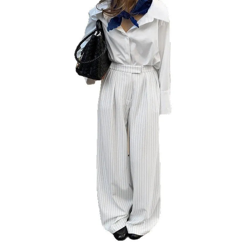 White striped wide-leg casual trousers with a zip closure on a hanger
