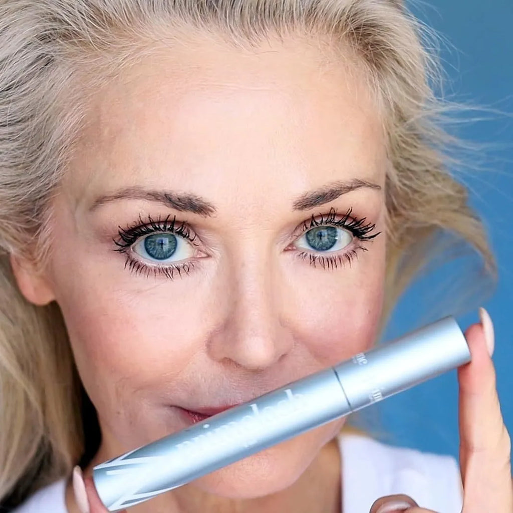 Close-up of a single eyelash brush and comb beauty tool for eye black application.