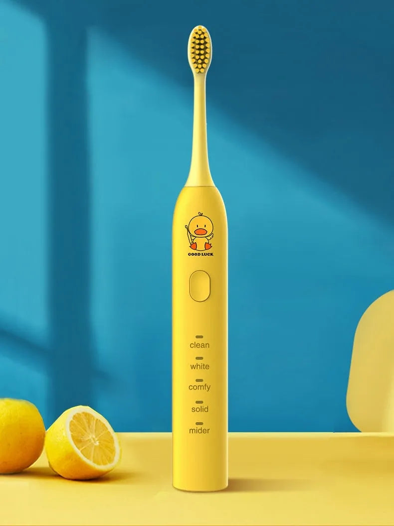 Rechargeable electric toothbrush in yellow with small duck design showing soft bristle brush head