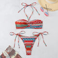 Women's green and orange striped halter-neck bikini set on a mannequin.