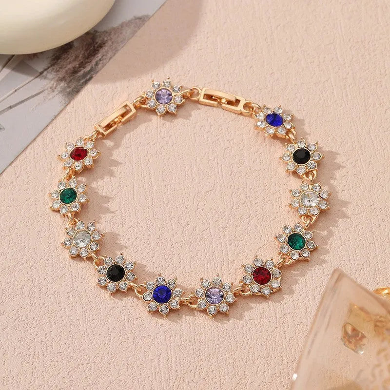 Flower-shaped bracelet with gemstone accents in gold or silver electroplated finish showing twelve colour combination options