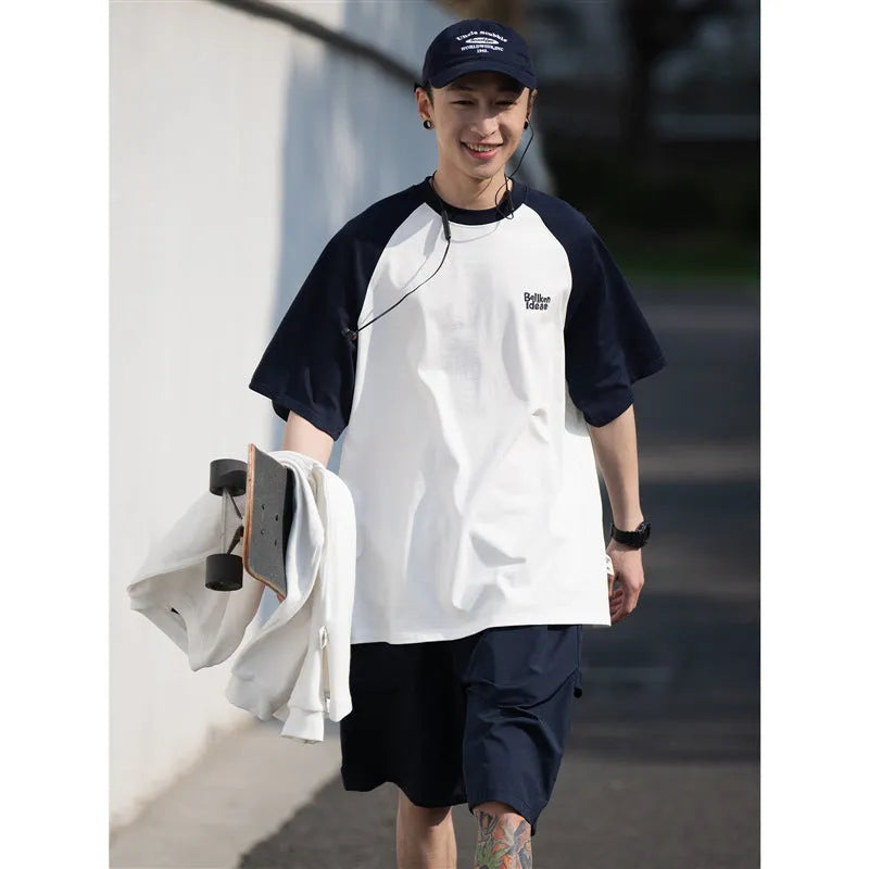 Blue Japanese-style loose men's t-shirt with raglan sleeves on a hanger