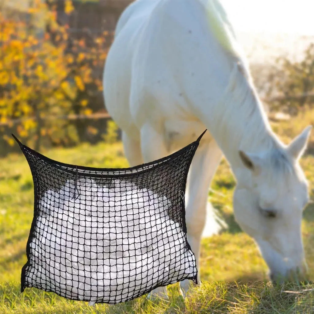 Black woven PE rope horse feeding bag with grid design hanging in stable