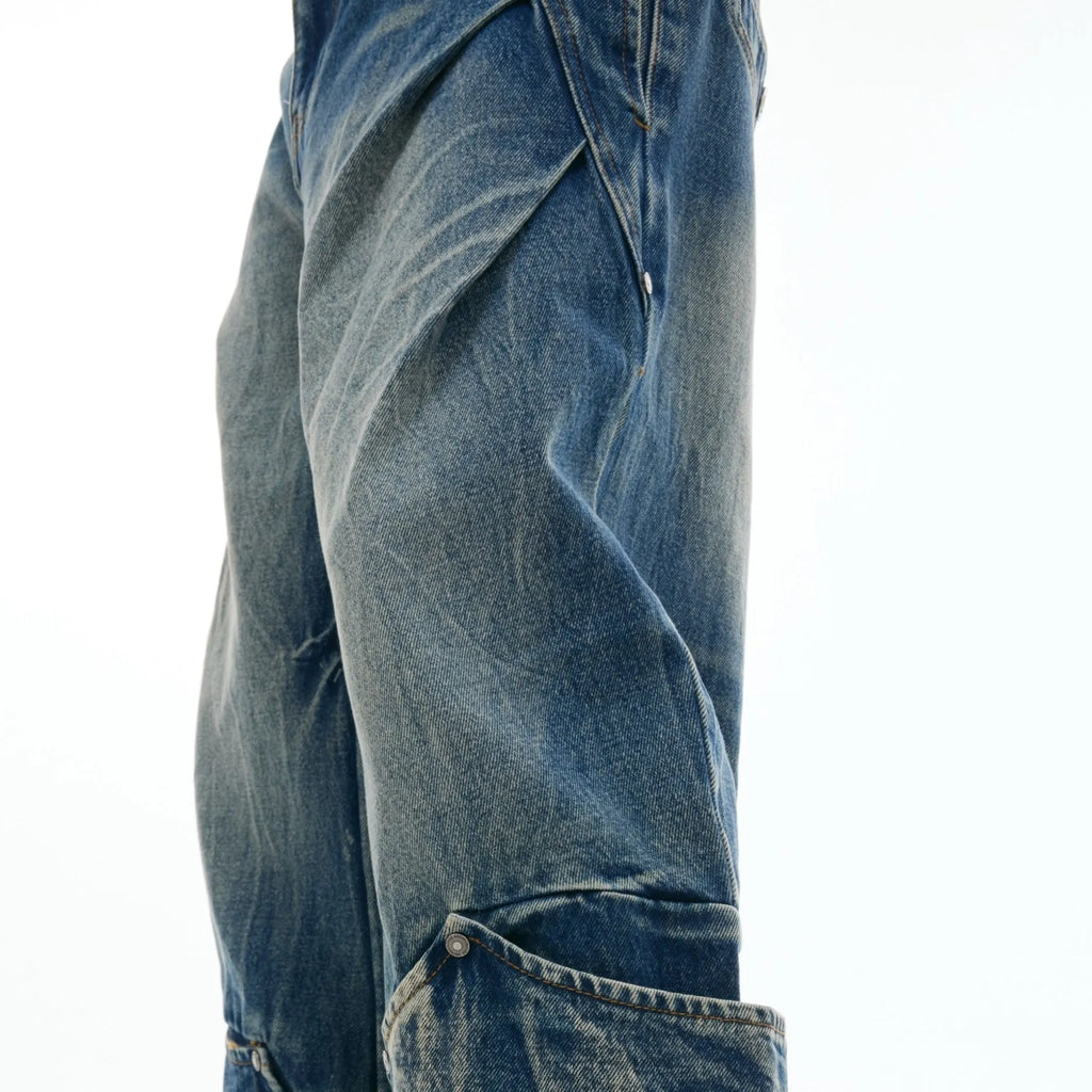 Men's verdant blue retro jeans with washed burst pattern showing curved knife fit and loose silhouette