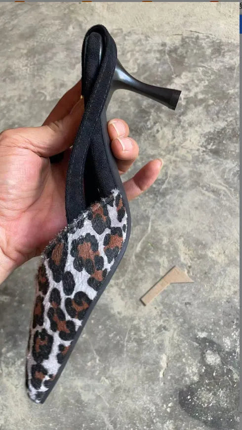 Women's leopard print suede sandals with a pointed toe design on a white background.