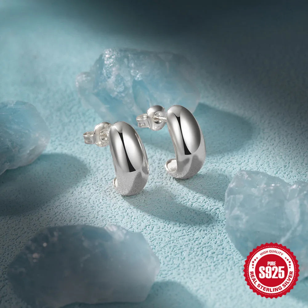 Sterling silver C-shaped stud earrings with glossy electroplated finish in geometric ring design