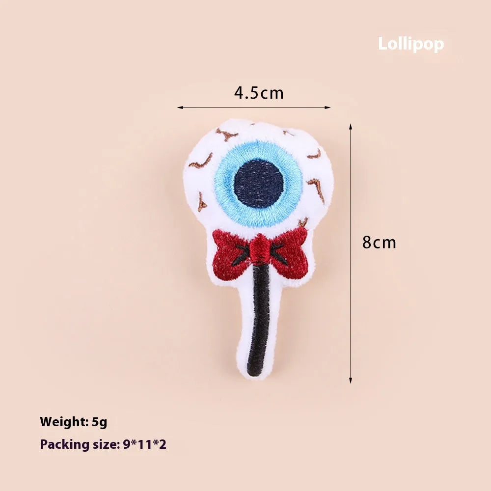 Small cat teaser wand with candy, eyes and skull plush attachments