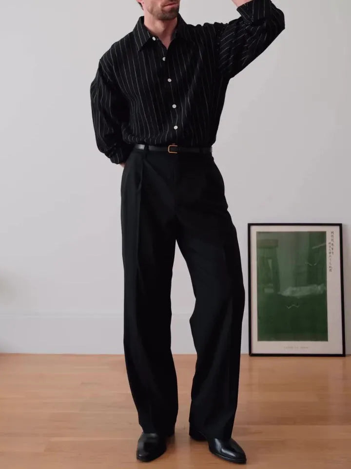 Black pinstripe button-down shirt on hanger showing striped pattern and button front