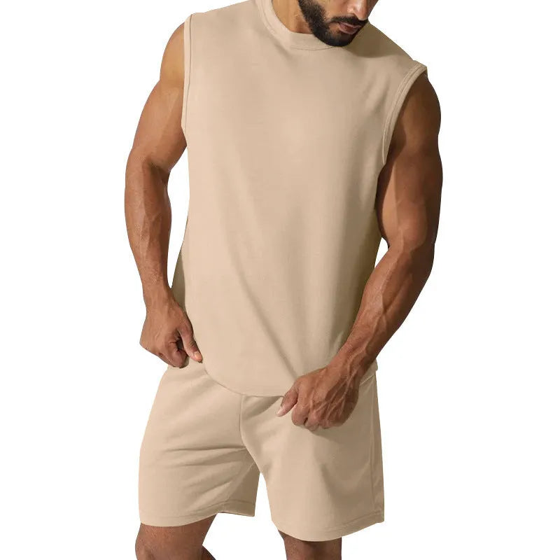 Man wearing a sleeveless army green top and matching shorts from a casual cotton blend sports suit set.