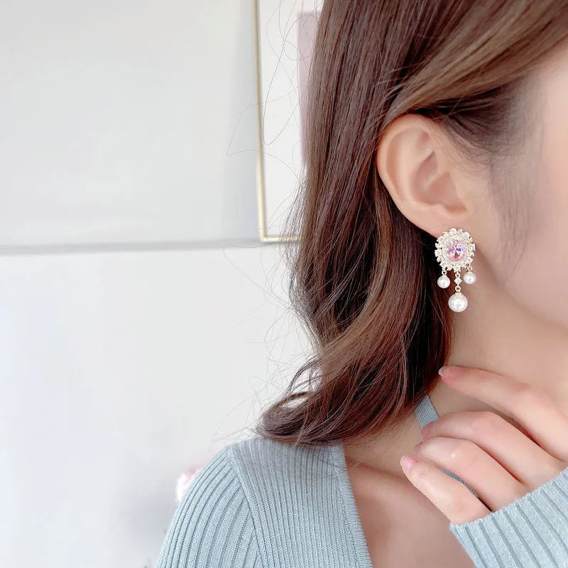 Copper oval earrings with zircon inlay and pearl tassels in light purple colour