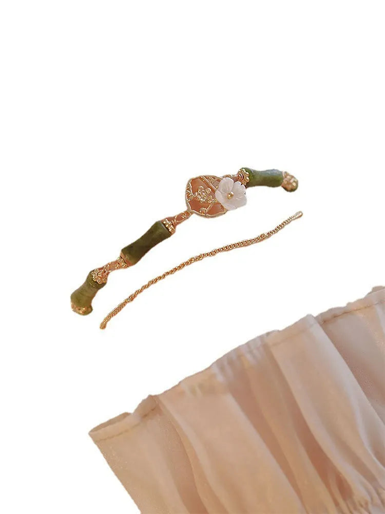 Handmade double layer olivine bracelet with Bells of Ireland charms on a model's wrist
