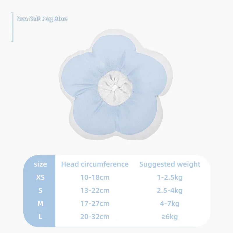 A soft blue cotton collar with flower print, fastened around a cat's neck as a protective recovery cone.