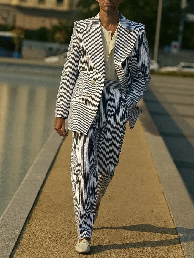 Blue and white striped polyester suit set with blazer and trousers on a hanger