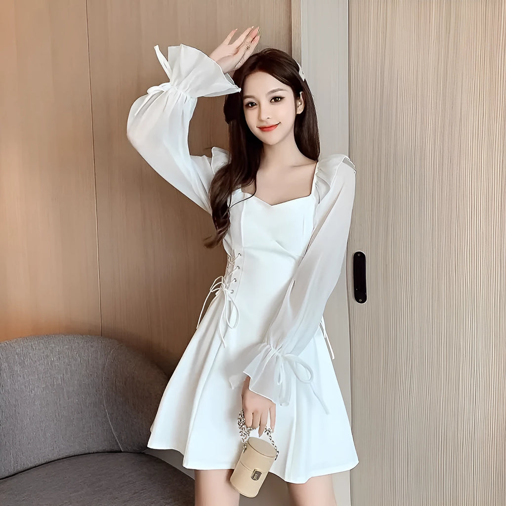 White waist-slimming chiffon patchwork dress with long sleeves on a woman