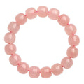 Pink crystal barrel bead bracelet with geometric 8x10mm beads on wrist