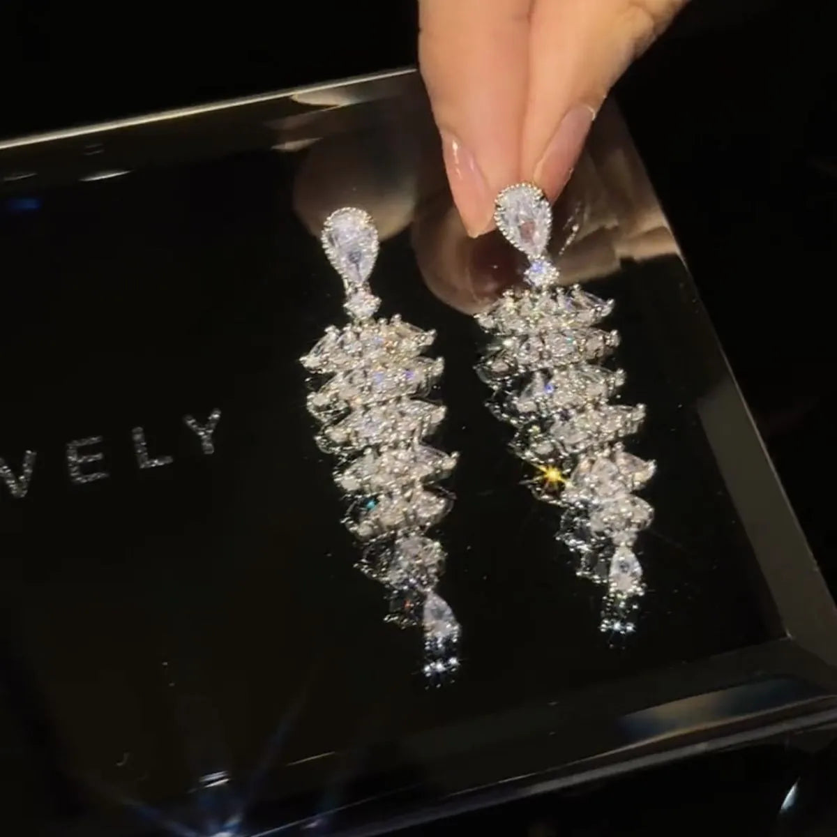 Silver Pagoda colour Christmas tree shaped drop earrings with stud fastenings and sparkling zircon finish.