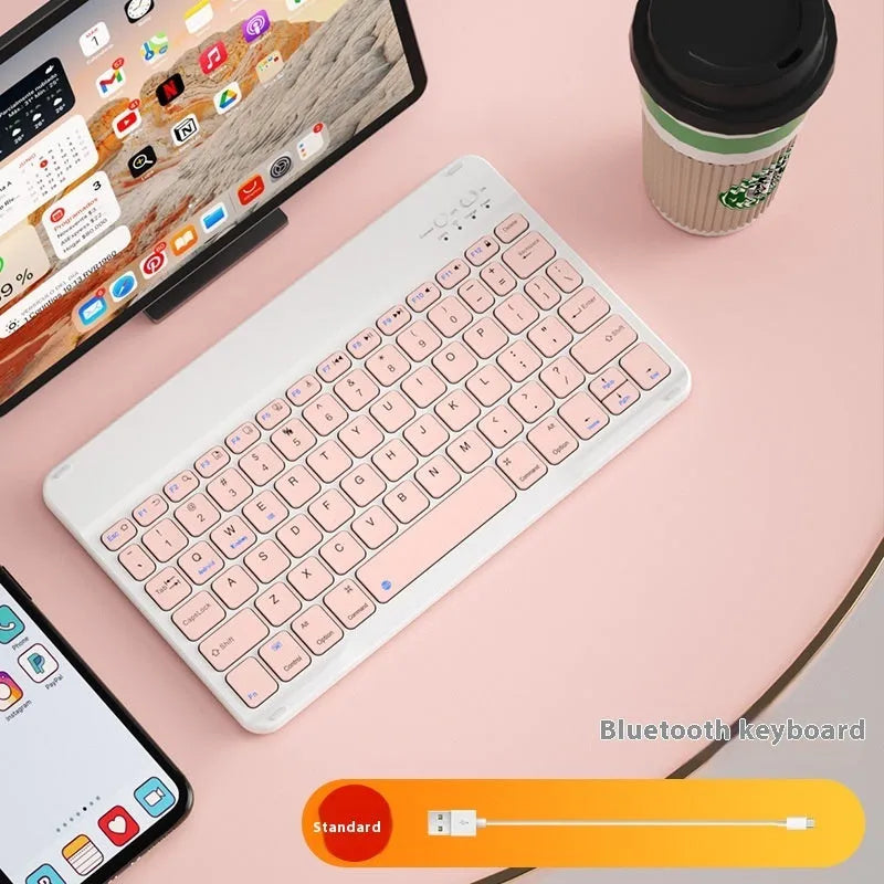 Compact white Bluetooth keyboard for tablet and PC use on a wooden desk