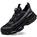 Lightweight black anti-smash work shoes with a steel toe cap and breathable Flyweave upper on a worksite.