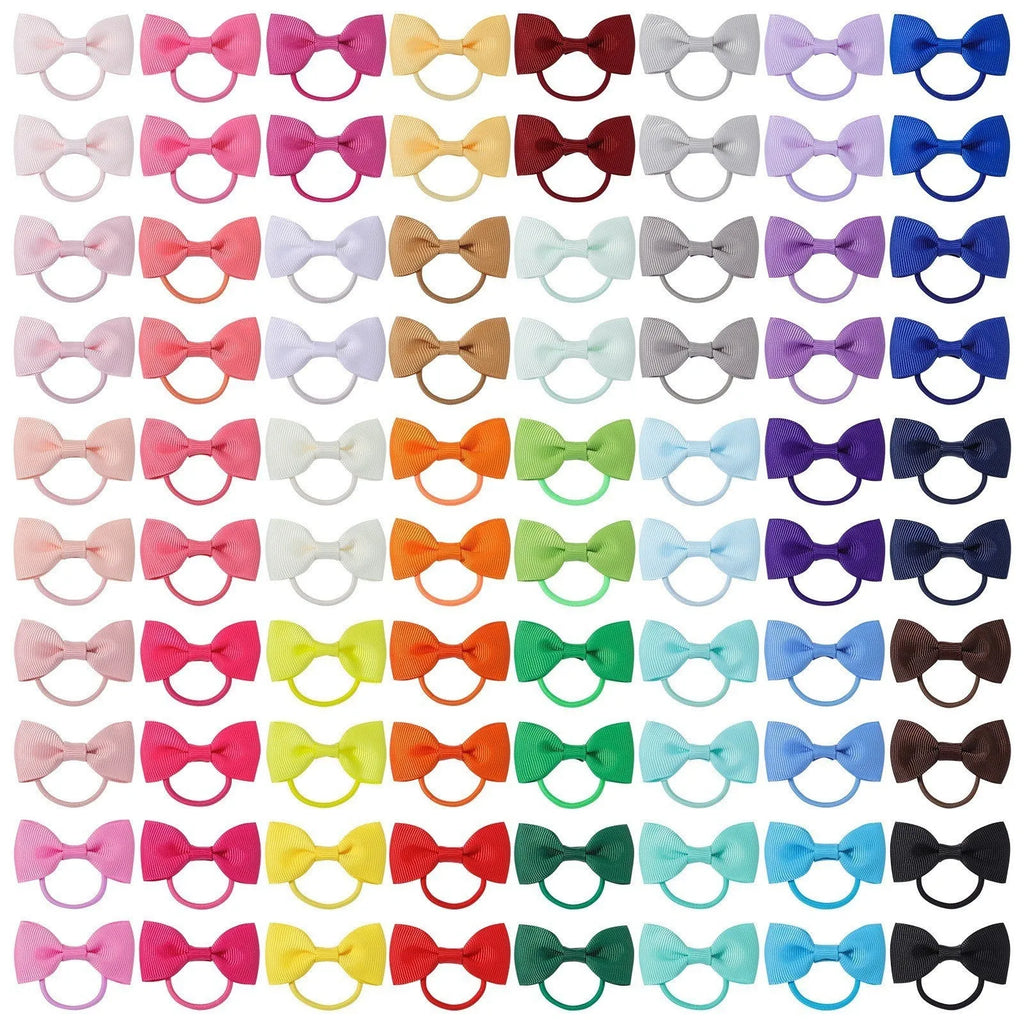 Multi-coloured baby hair ties with small grosgrain ribbon bows, soft elastic bands for infants and toddlers.