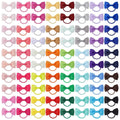Multi-coloured baby hair ties with small grosgrain ribbon bows, soft elastic bands for infants and toddlers.