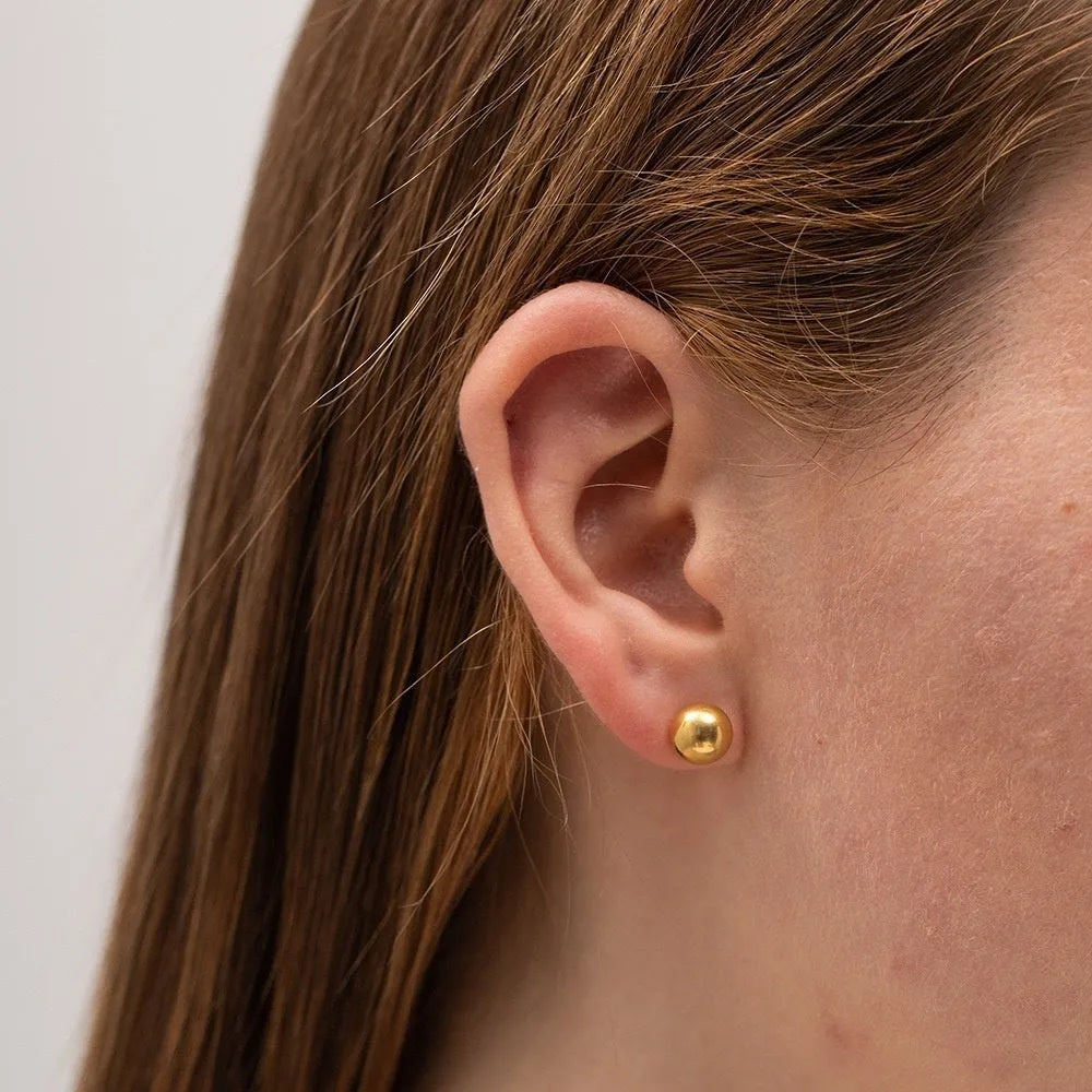 Gold and silver spherical ball stud earrings in 3mm, 4mm, 5mm, and 6mm sizes on a plain background.