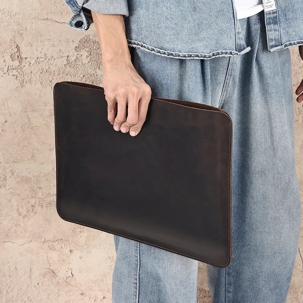 Brown genuine cowhide leather horizontal computer liner bag with a solid colour pattern.