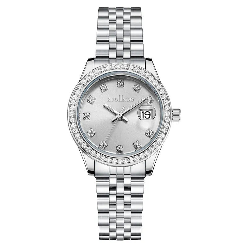 Women's silver alloy quartz watch with calendar display on a wrist