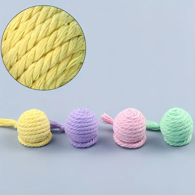 Colourful cat toy ball with a rope and built-in bell for interactive kitten play.