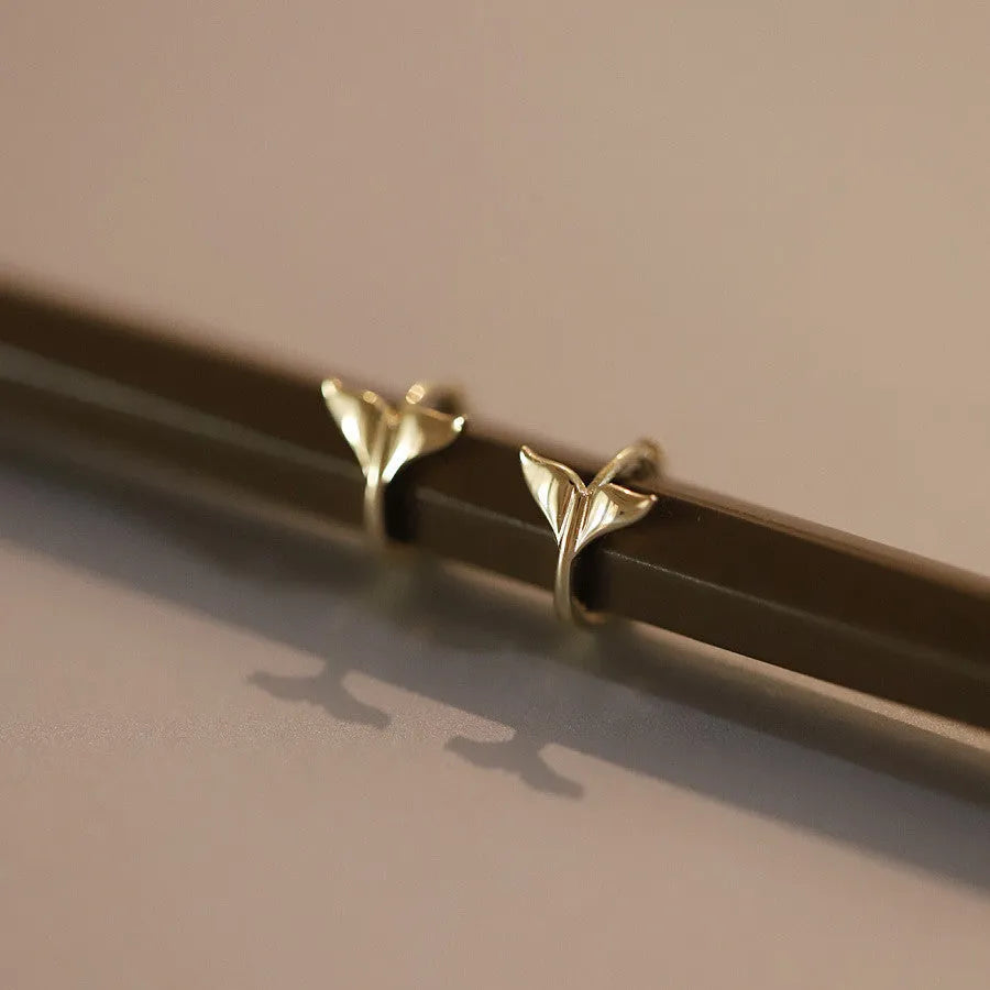 Gold plated sterling silver fish tail earrings for women, showing simple design and smooth finish.