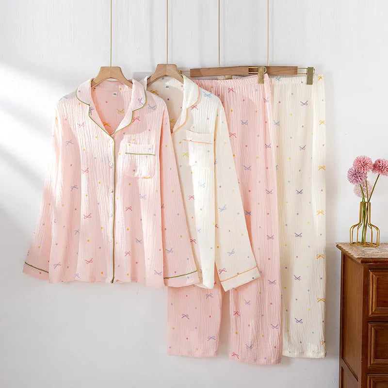 Women's lightweight pink cotton pyjama set with long sleeves and full-length trousers.