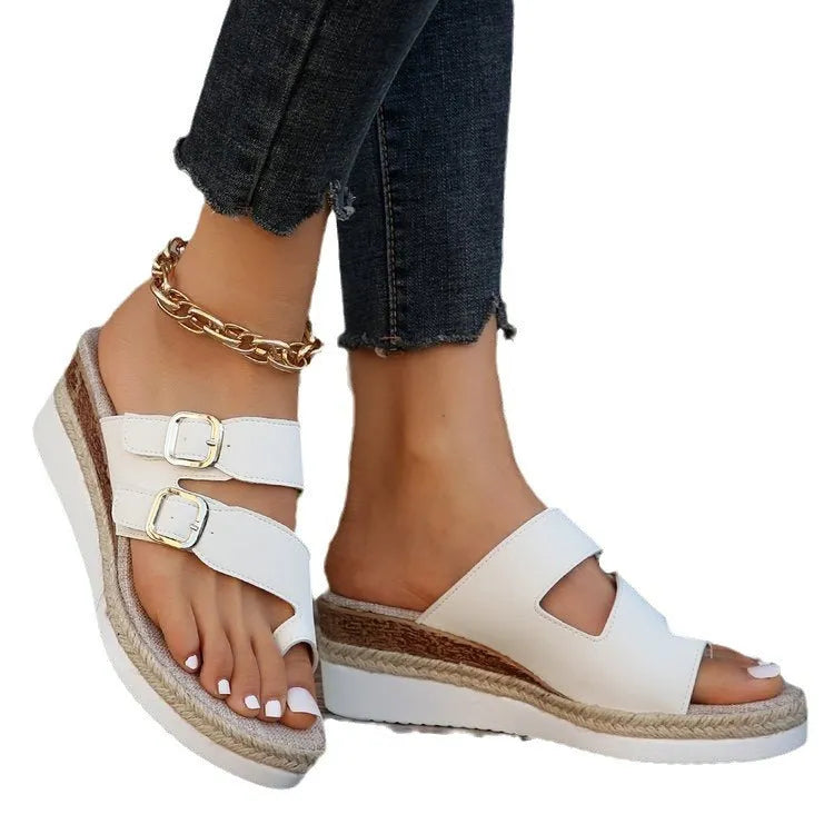 White casual wedge sandals with woven patent leather upper and peep toe design on a foot.
