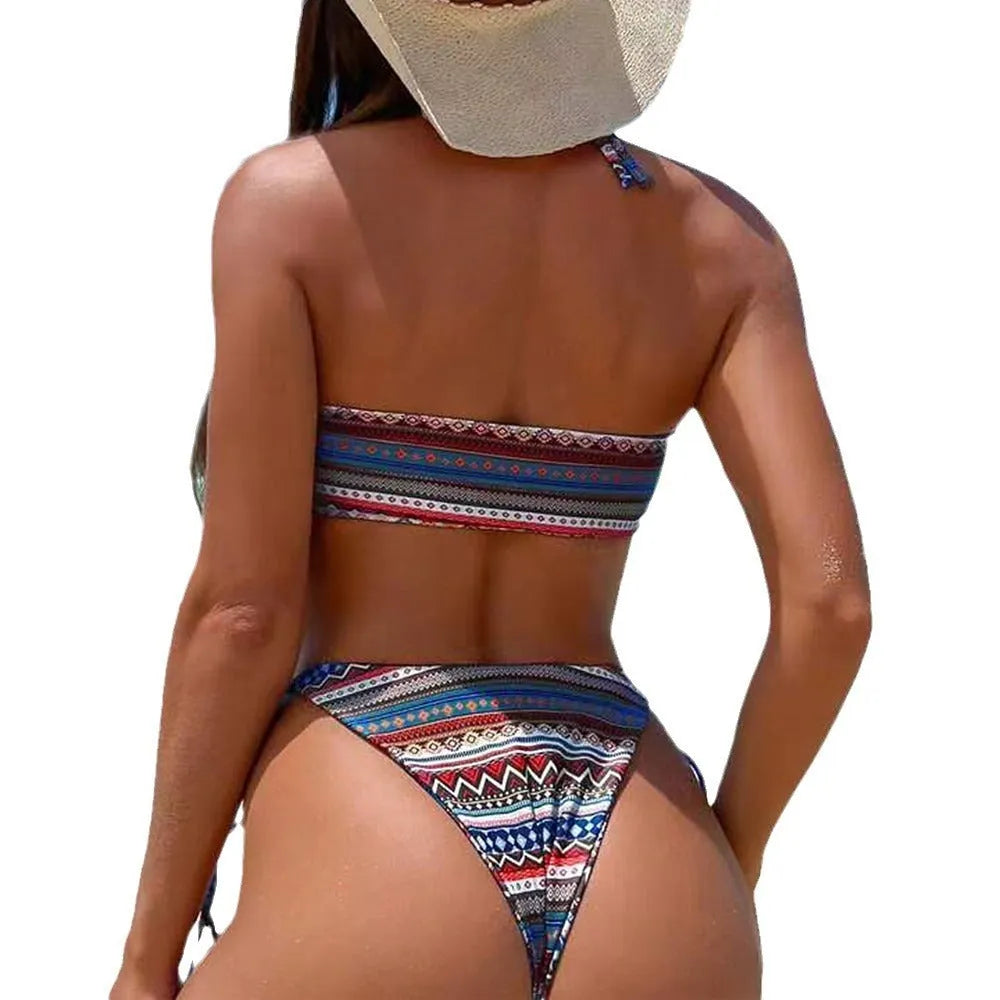 Women's green and orange striped halter-neck bikini set on a mannequin.