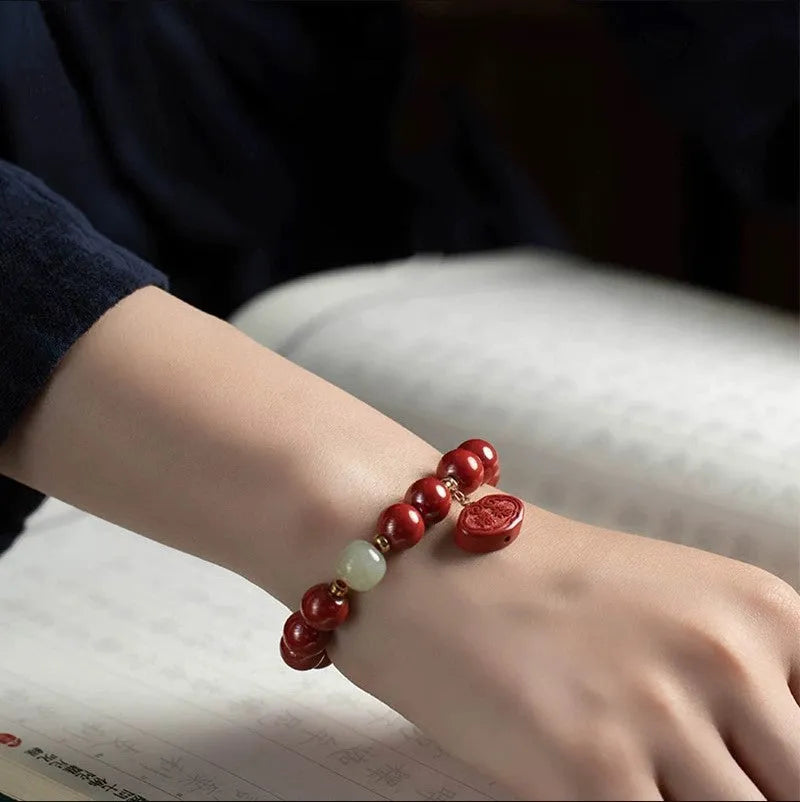 Natural red cinnabar bracelet with Ping An Fu Lu symbol carved in emperor sandstone style.