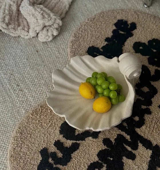 White resin simulation shell fruit plate decoration ornament on a table