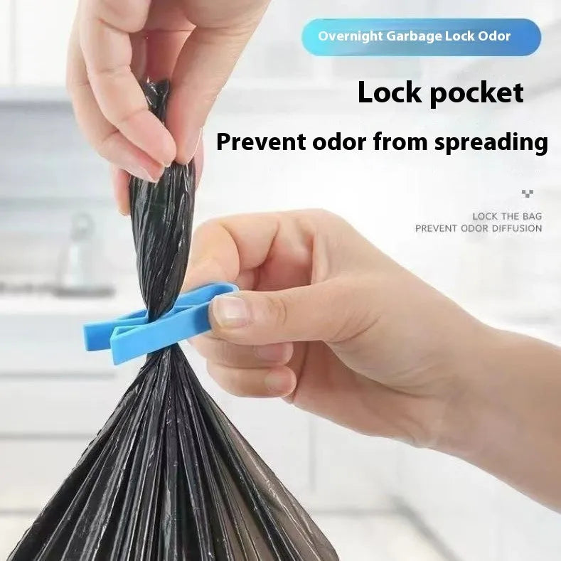 White PP plastic garbage bag fixing clip shown holding a black bin liner to the rim of a silver trash can.