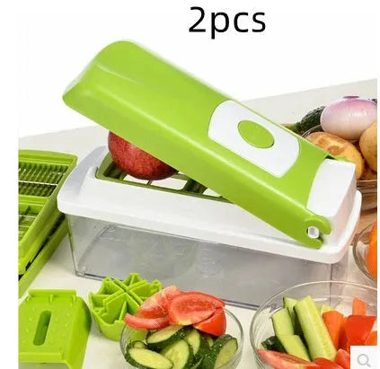 Green manual vegetable chopper with stainless steel blades and multiple cutting accessories on kitchen counter