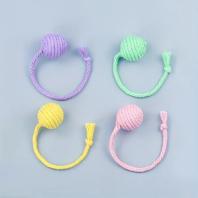 Colourful cat toy ball with a rope and built-in bell for interactive kitten play.