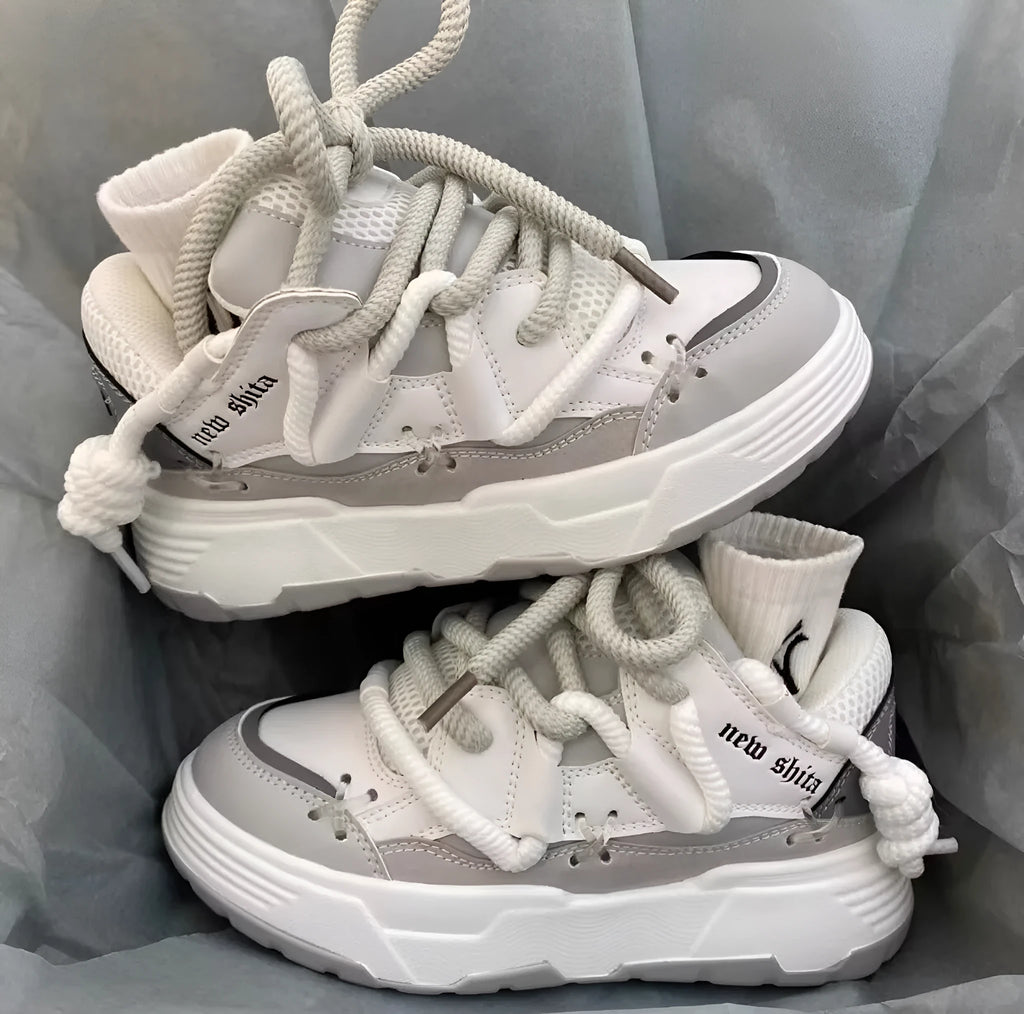 Women's grey retro clunky sneakers with thick rubber platform sole and lace-up front.