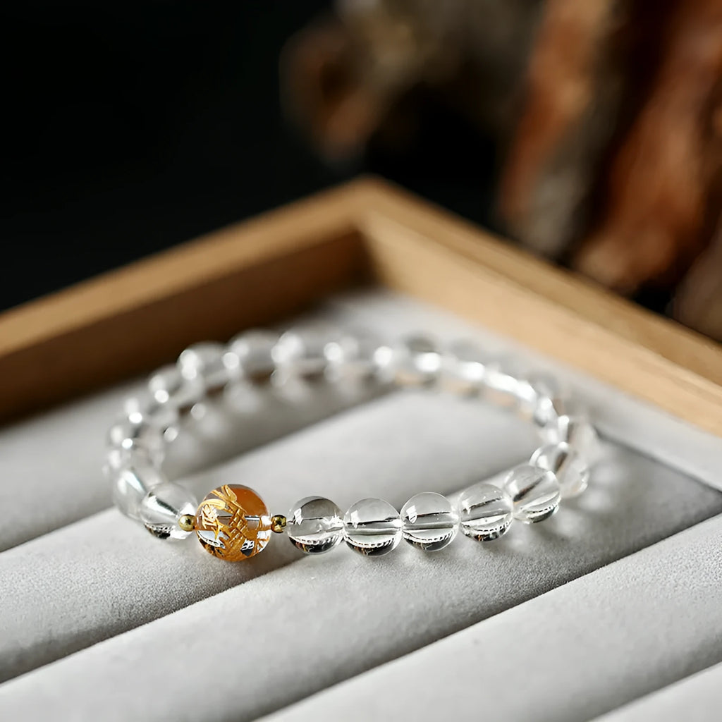 Geometric obsidian black agate white crystal bead bracelet with gold dragon charm on wrist
