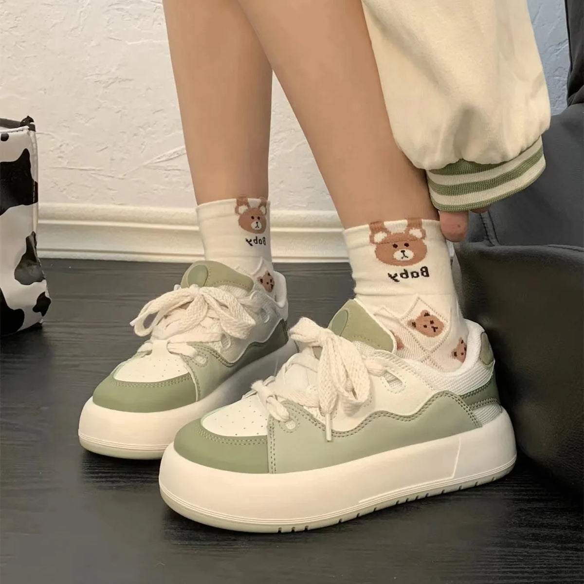 Green women's casual shoes with PU mesh upper and flat heel design on white background