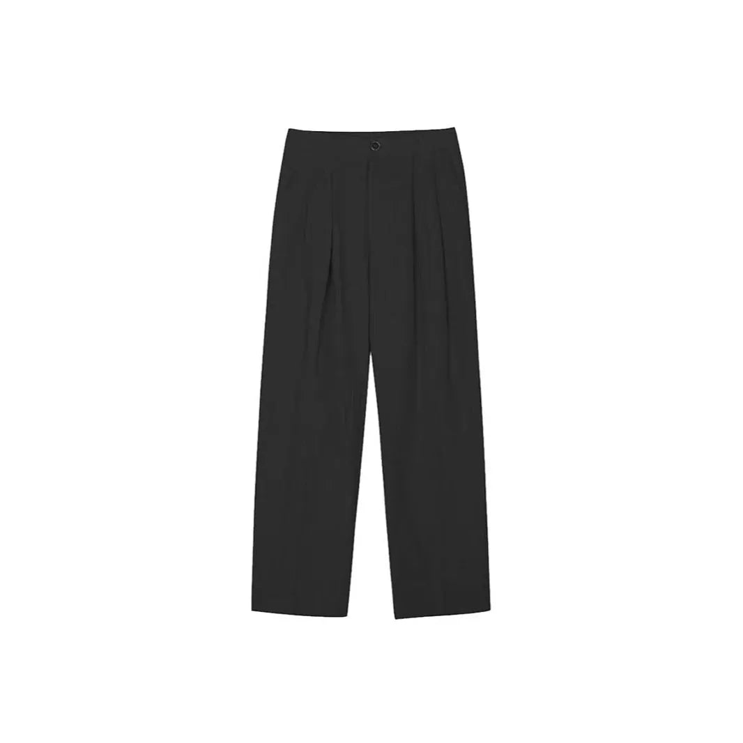 Men's apricot coloured loose-fit cotton linen trousers with a pencil leg on a plain background