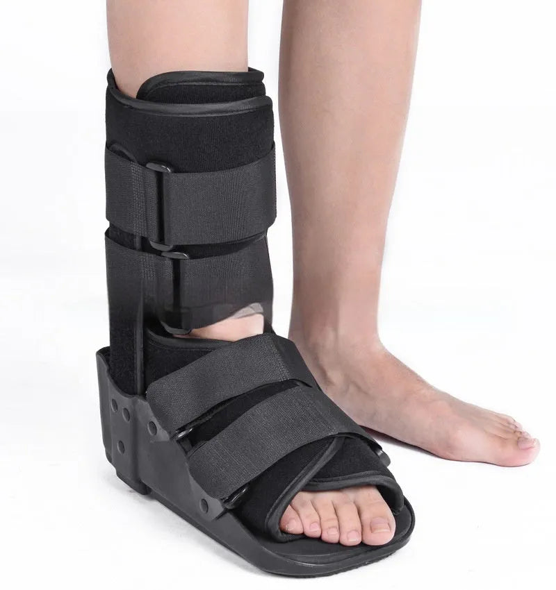 A black Achilles tendon rehabilitation boot with fixed support, showing straps and structural design.
