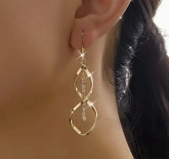 Gold geometric spiral earrings with ellipse design elements on alloy construction