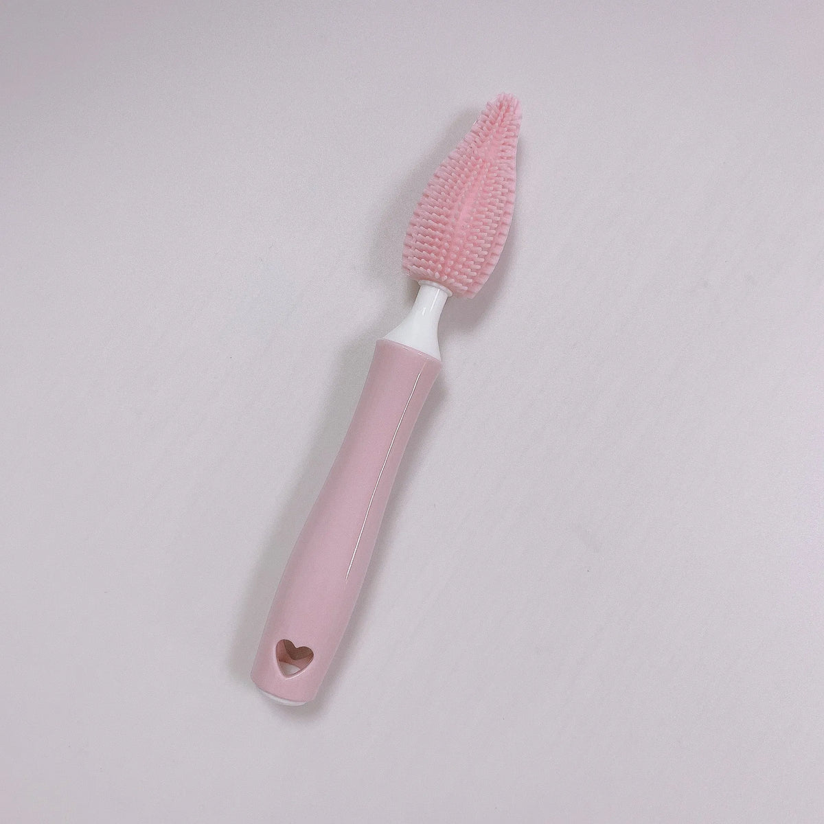 Pink, blue, and yellow silicone baby bottle brush sets with a straw cleaning brush.