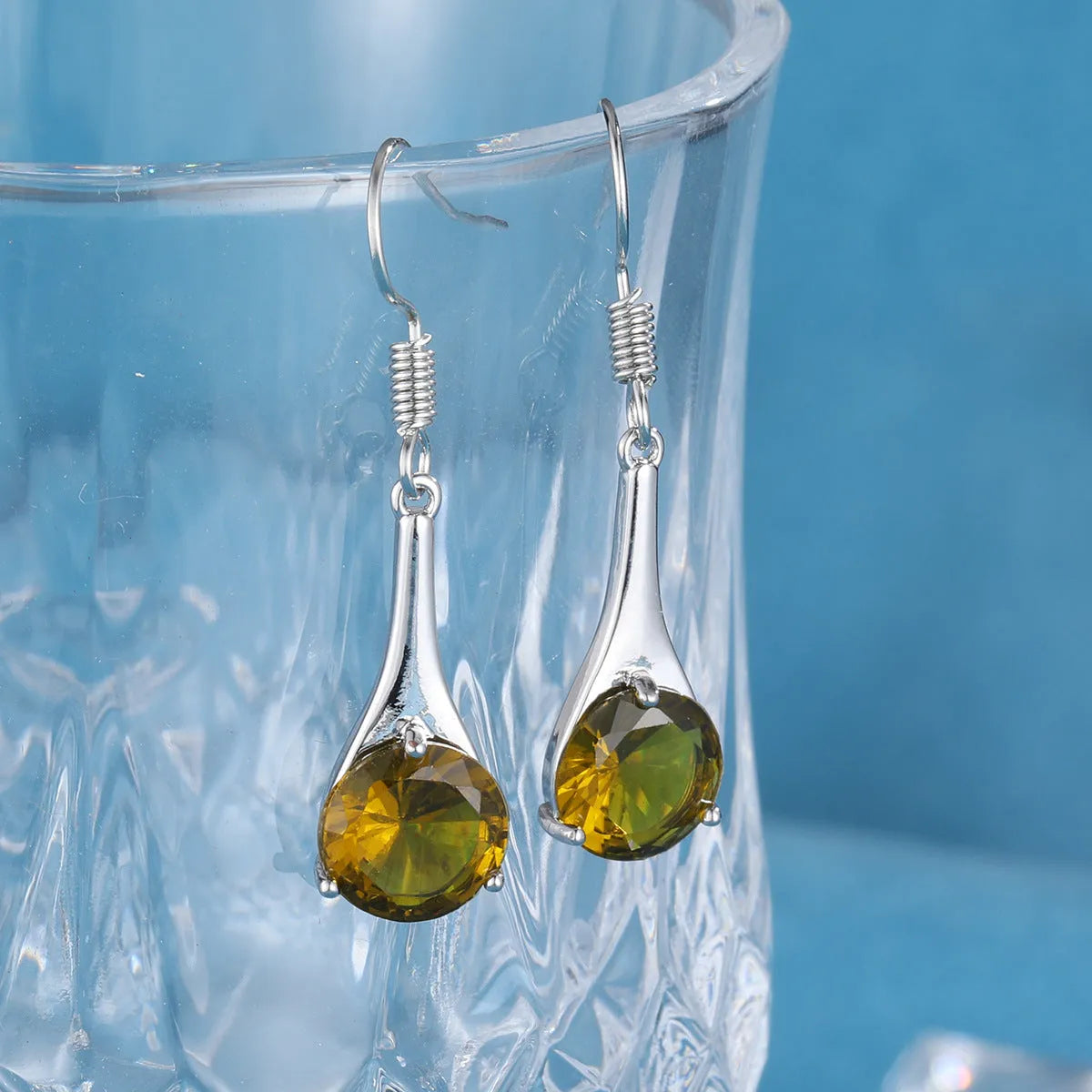 Olive green topaz water drop shaped earrings with retro design and minimalist styling