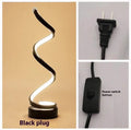 Minimalist black or white LED desk lamp with aluminium shade on a metal base.
