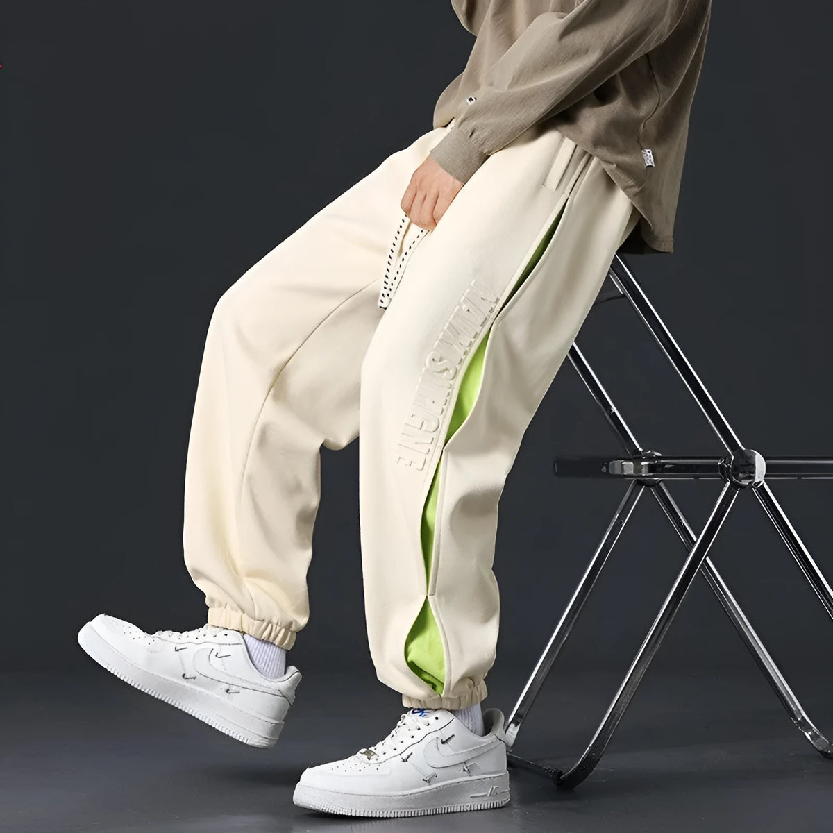 Men's loose-fit cotton trousers with stitching print detail and a banded ankle cuff.