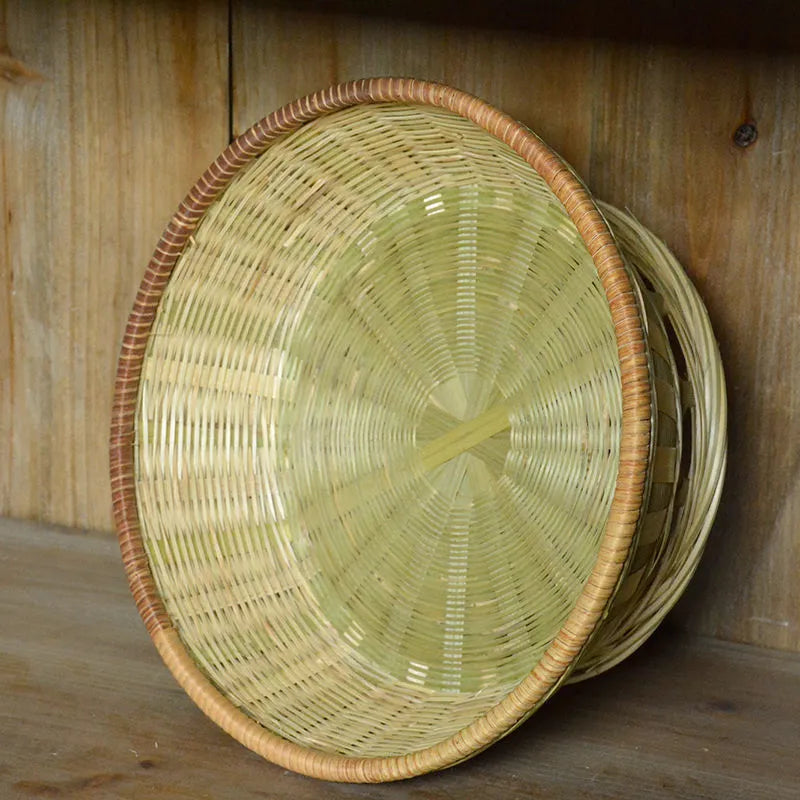 Handmade woven natural bamboo storage basket shown in one of three size options.