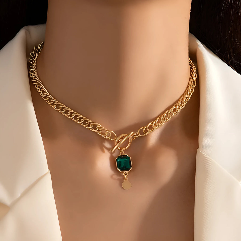 Gold electroplated titanium steel necklace with emerald zircon geometric pendant on Cuban link chain