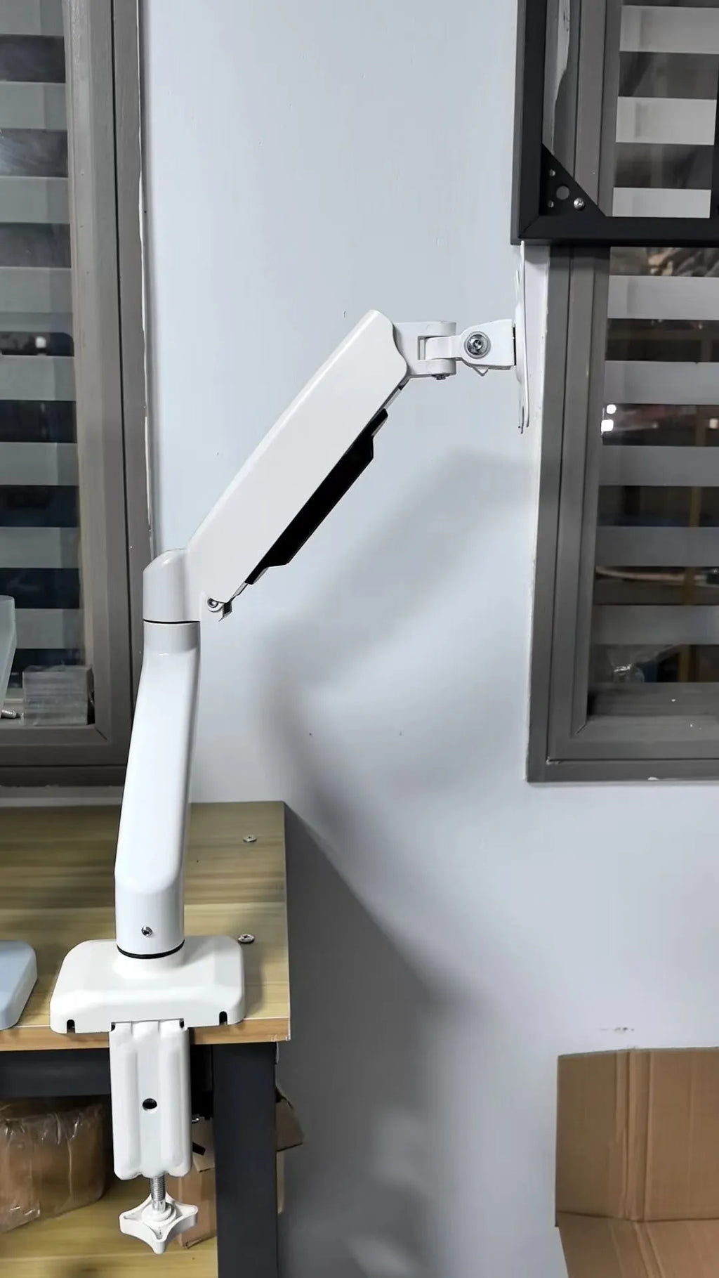 Black rotating telescopic LCD screen bracket showing height adjustment and rotation functions
